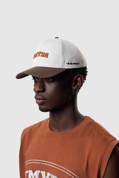 Person wearing a cream cap and sleeveless orange t-shirt on a white background