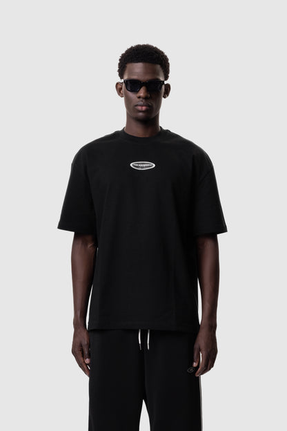 Person wearing a black t-shirt with a logo on a white background