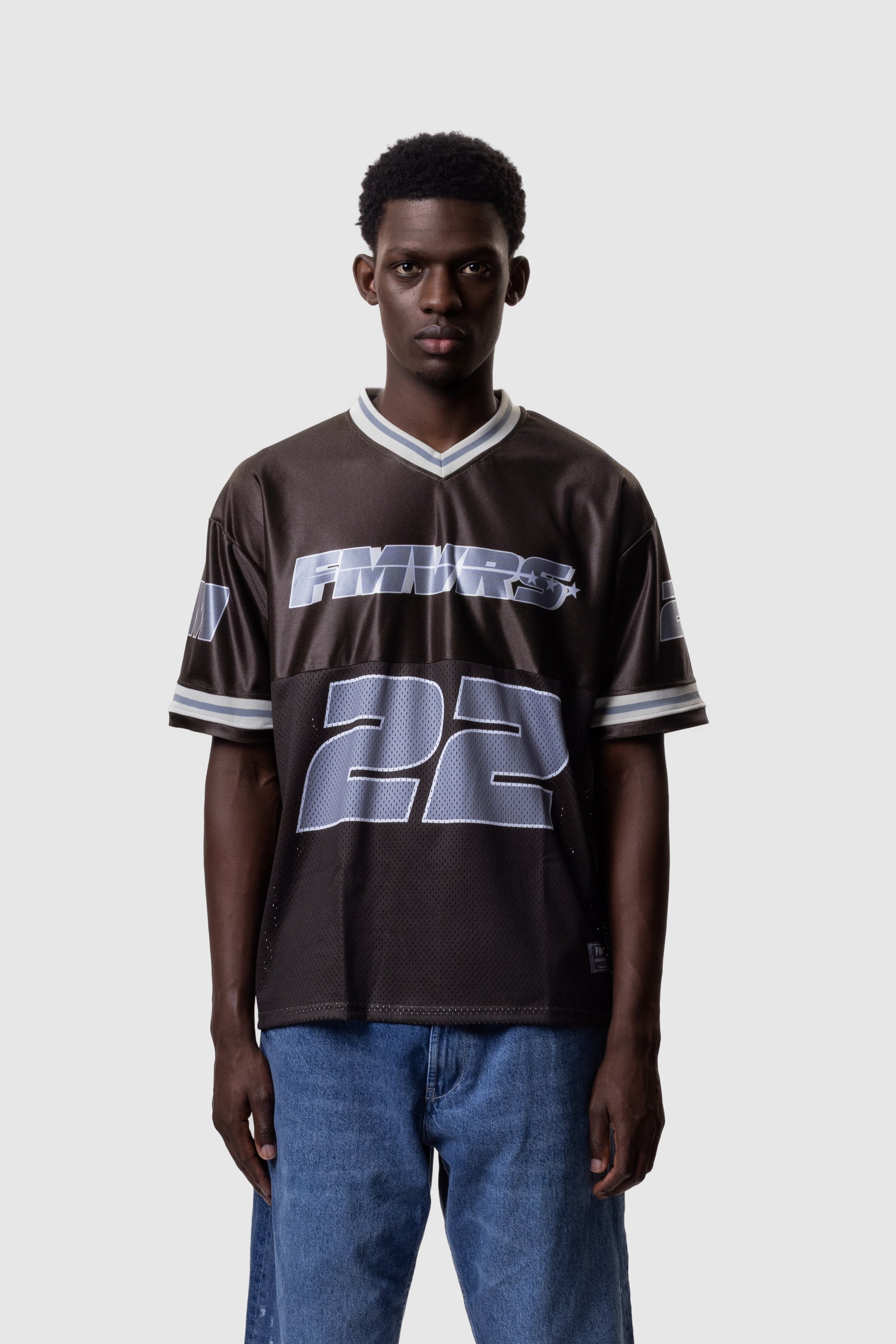 Person wearing a brown sports jersey with '22' on a white background