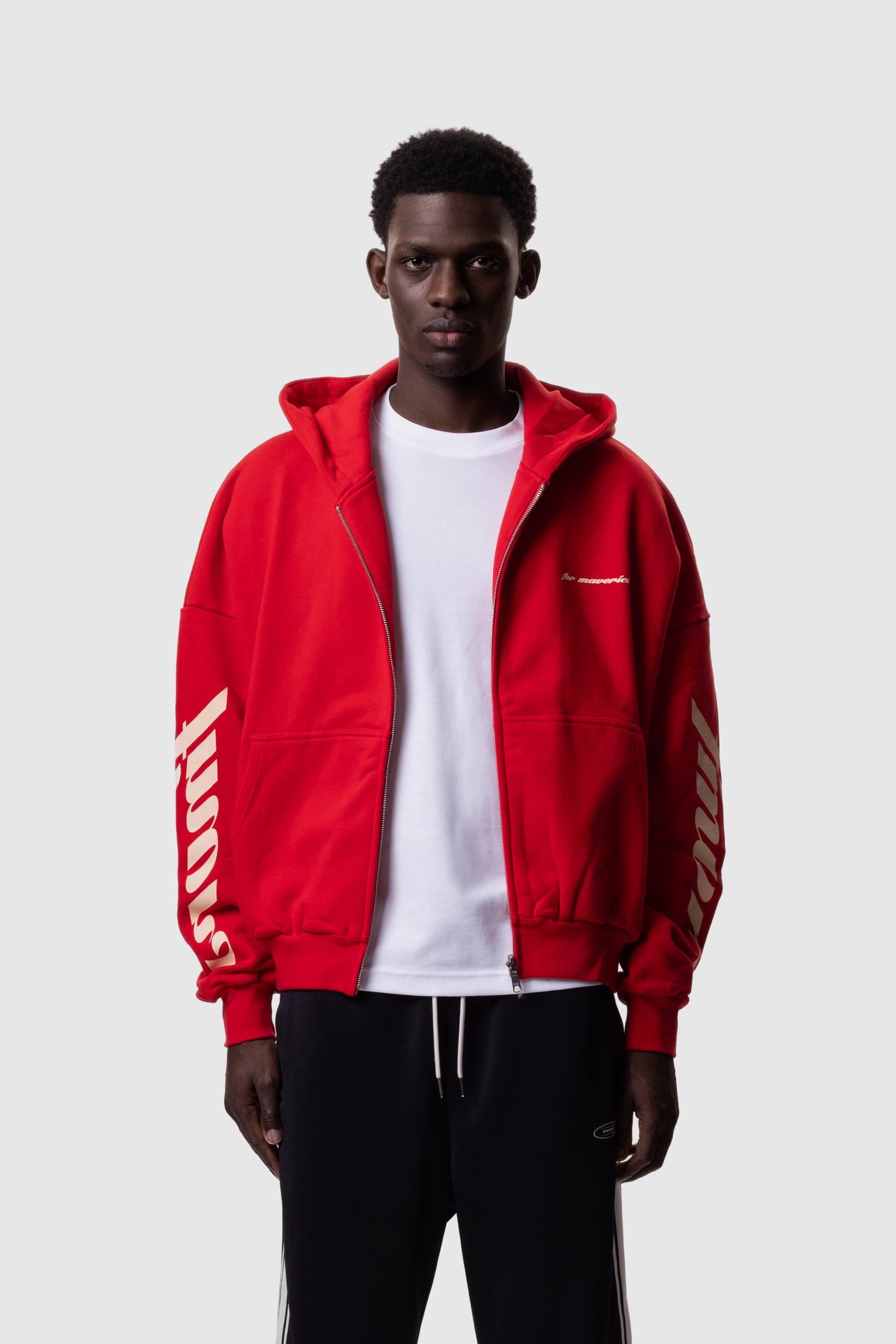 Person wearing a red hoodie with FMRVS branding on a white background