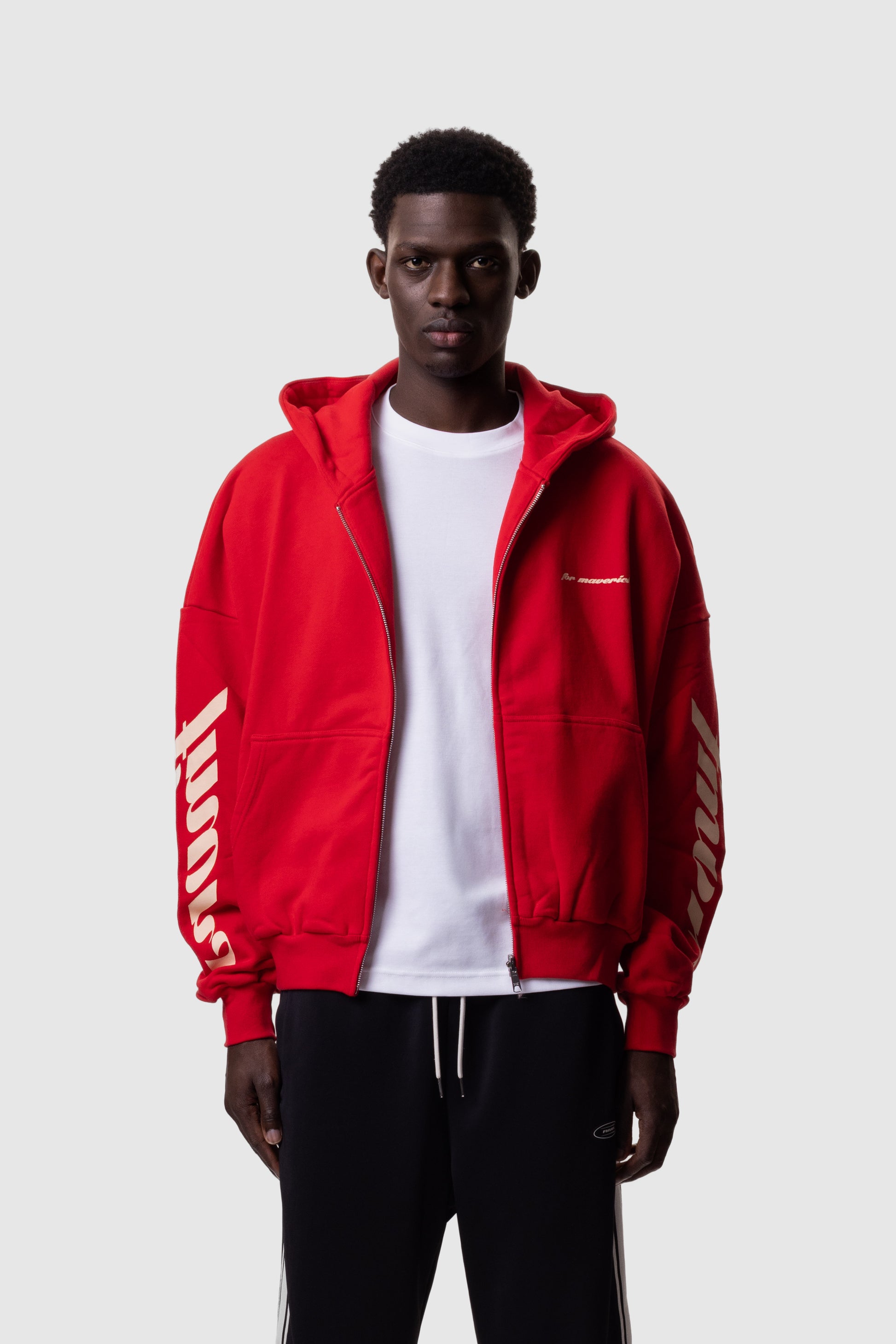 Person wearing a red hoodie with FMRVS branding on a white background