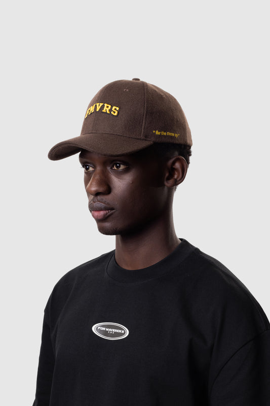Person wearing a brown cap with 'FMVRS' logo and black t-shirt with logo on a white background